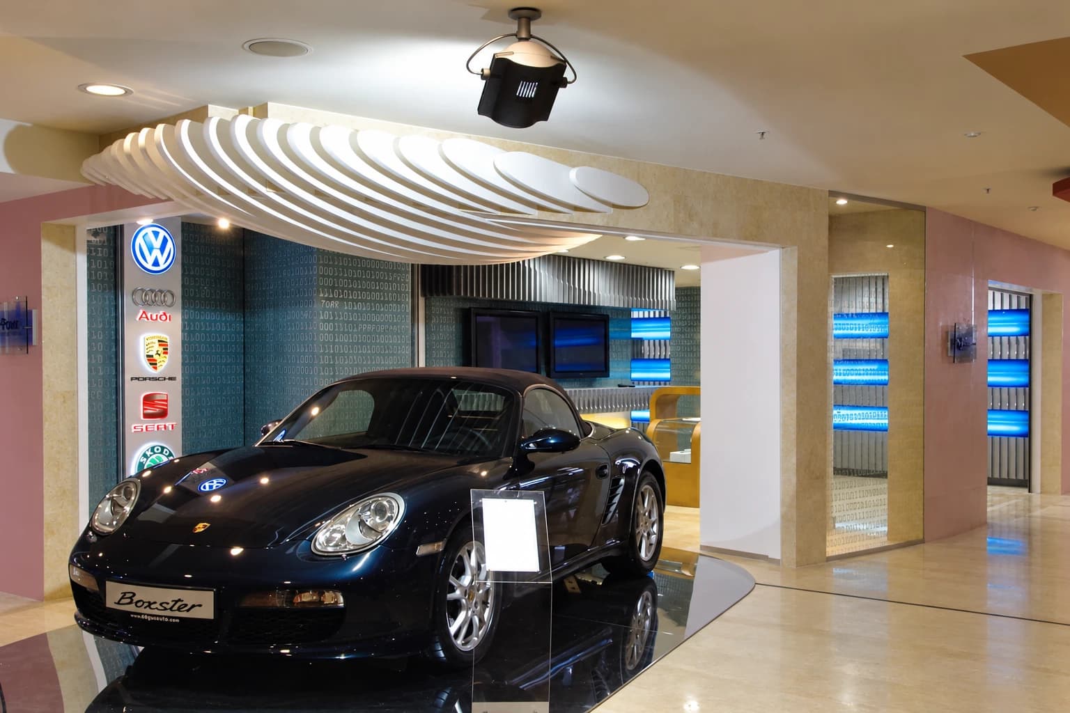 D-Point Showroom — Mayadrom: Araç, eğrisel tavan elemanları ve showroomun genel görünümü